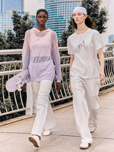 a lady wears a white T-shirt with white cargo pants